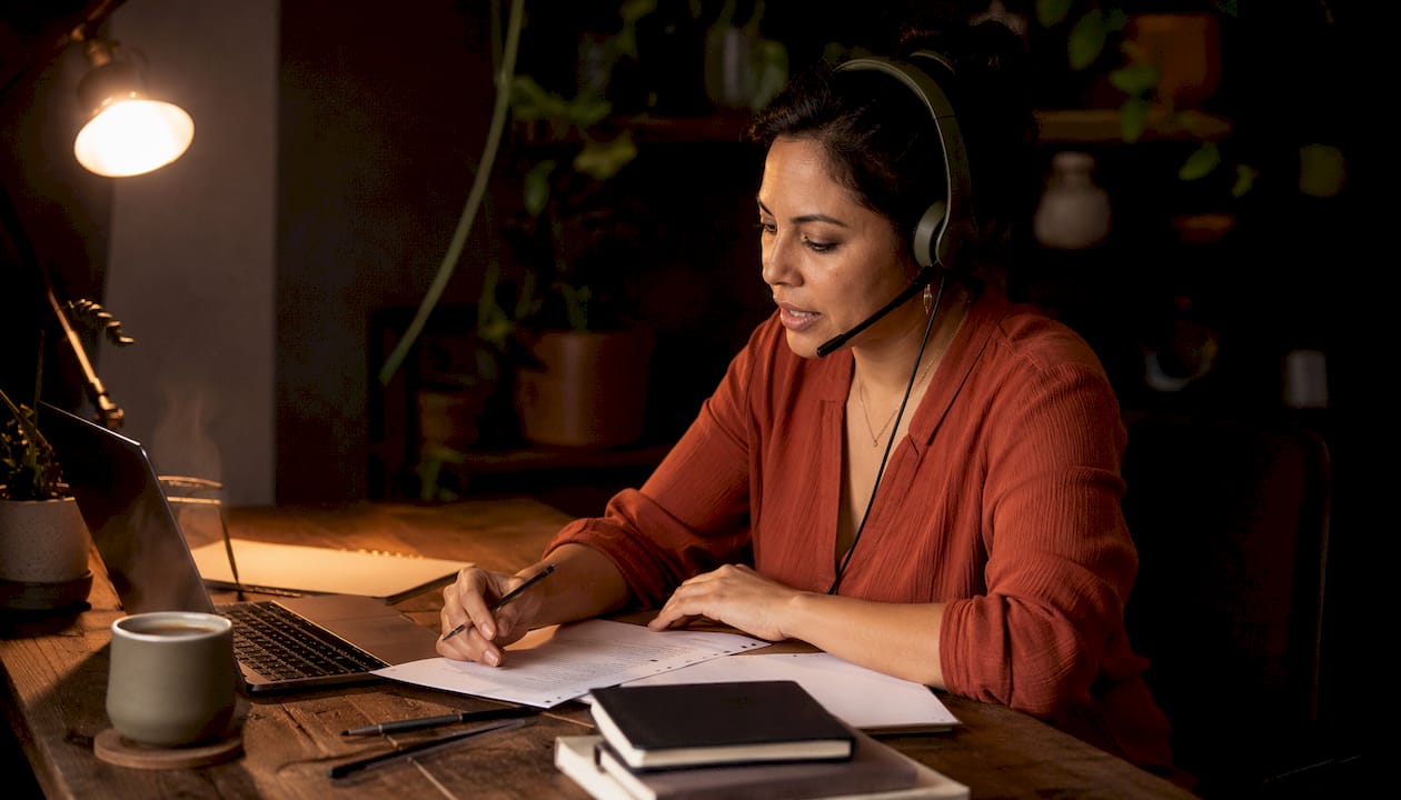 Customer service representative speaking on phone in call center
