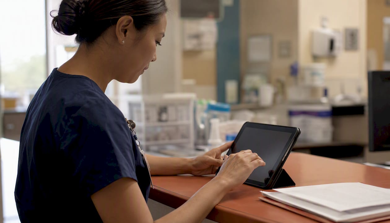 Hands preparing bilingual discharge instructions