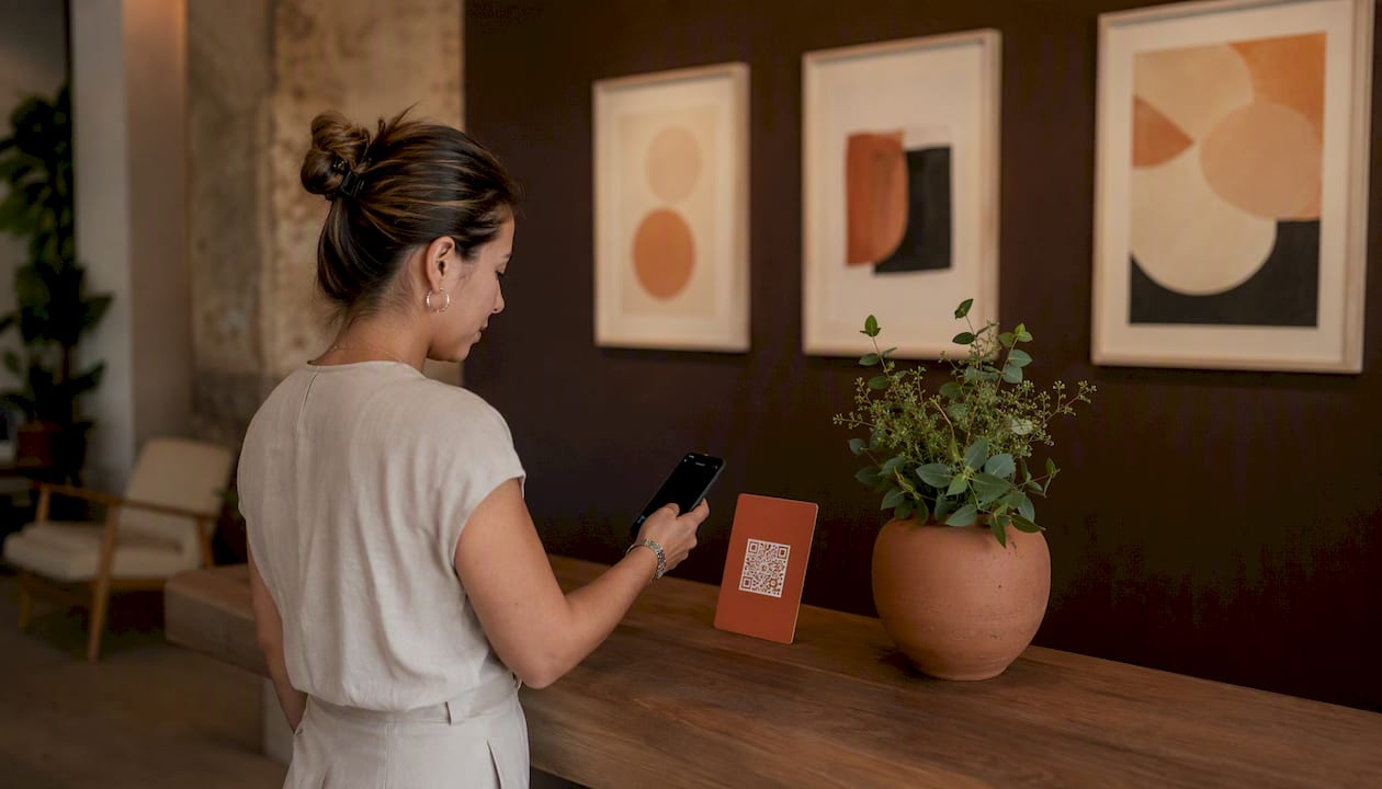 Person scanning WhatsApp QR code card