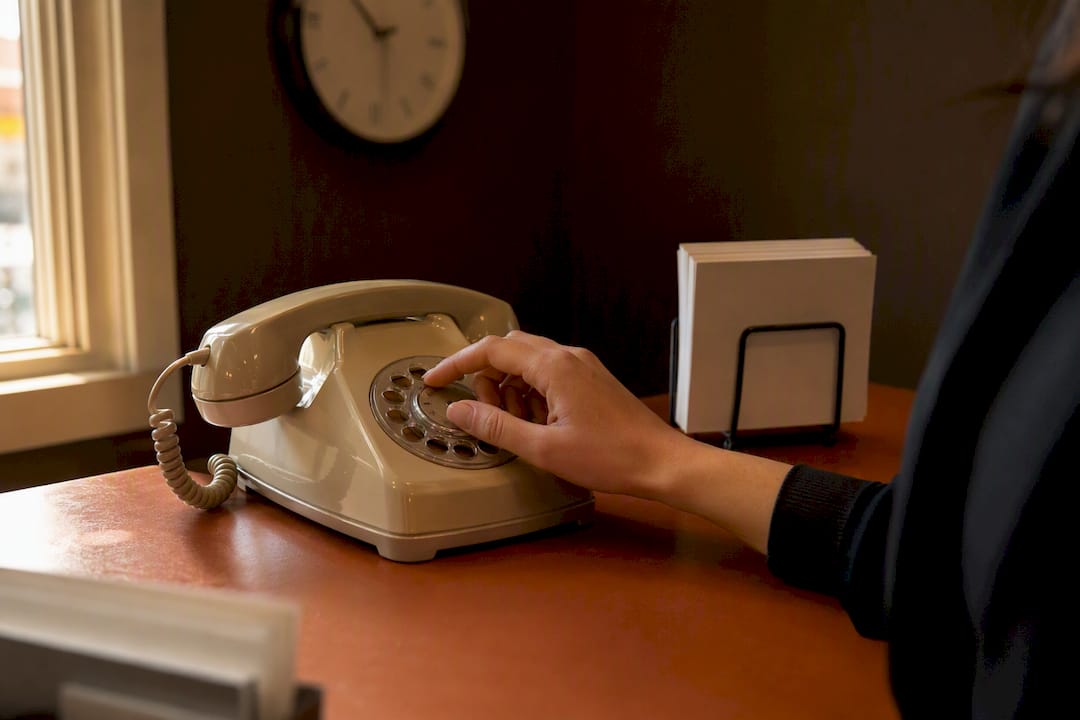 Manos usando un teléfono en la recepción médica