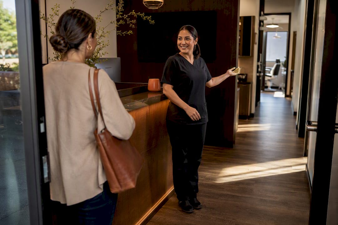 Receptionist greeting Spanish-speaking dental patient
