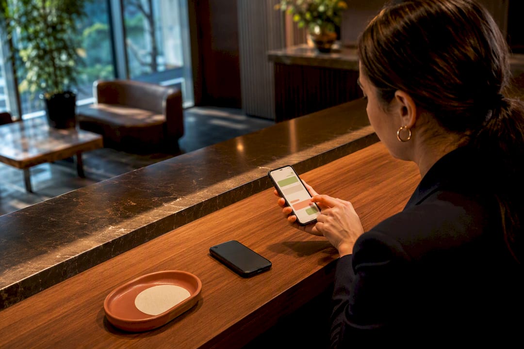 Hands reviewing a WhatsApp appointment request