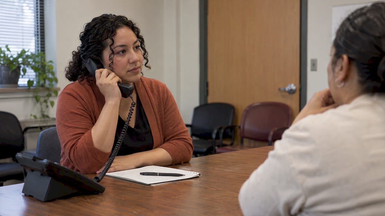 Receptionist practicing Spanish clinic phone etiquette
