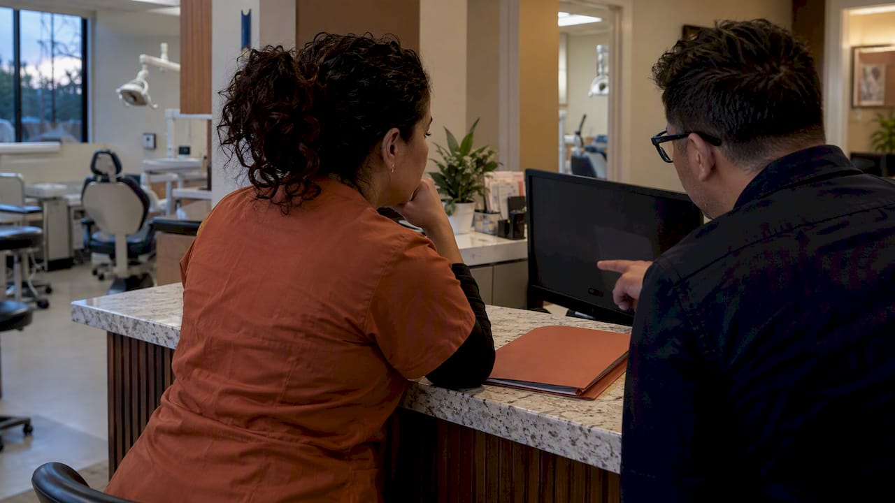 Dental practice owner reviewing bilingual website launch